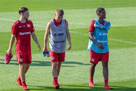 Football player Adrian Stanilewicz, Daley Sinkgraven and Leon Bailey walking barefoot over the ...