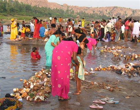 many people are standing in the water near trash