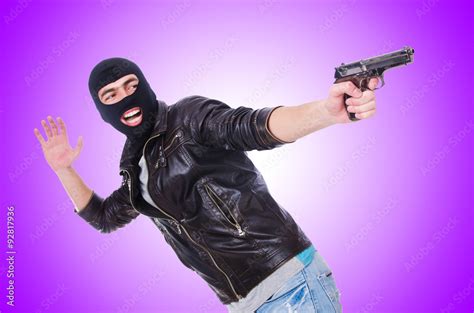 Young thug with gun isolated on white Stock Photo | Adobe Stock