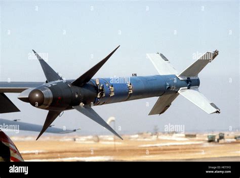 A close-up view of an AIM-9L Sidewinder training missile mounted on the wingtip of an F-16 ...