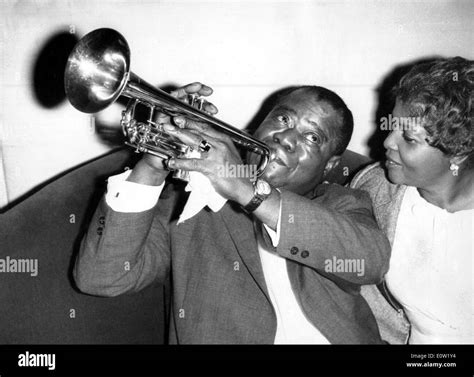 Louis Armstrong playing the trumpet for his wife Lucille Stock Photo ...