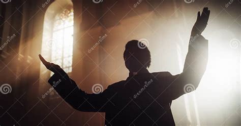 Portrait of Christian Priest Raising Hands in Blessing His Congregation while Praying in Church ...