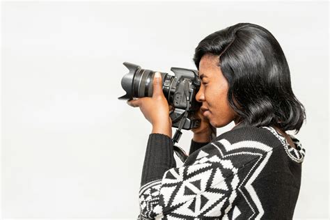 Black female photographer taking photo on camera · Free Stock Photo