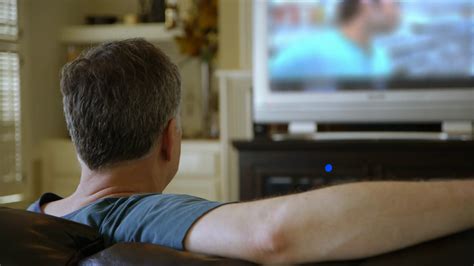 Man Sitting On Couch Watching Tv Turns Stock Footage SBV-300978537 - Storyblocks