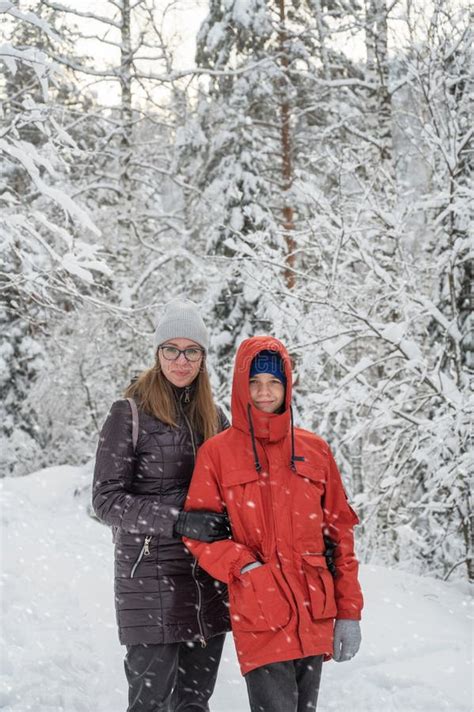 Woman with Her Son Walking in Snowy Winter Forest Stock Photo - Image of winter, snowing: 258724262