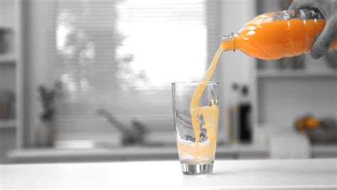 Man Pouring Orange Juice In His Glass In Slow Motion Stock Footage ...