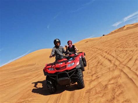 Dubai: Evening Desert Quad Bike Tour with BBQ Dinner | GetYourGuide