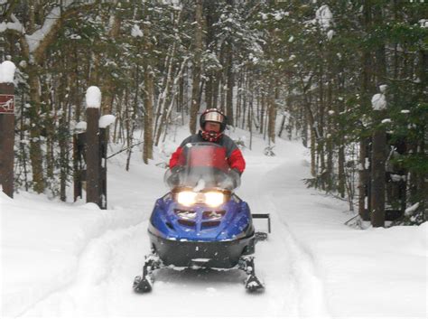 Grooming trails with a snowmobile at Catamount Forest in Colton