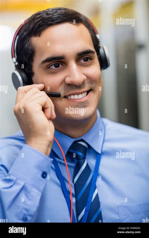 Technician talking on head phones Stock Photo - Alamy