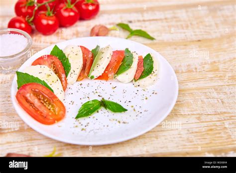 Italian caprese salad with sliced tomatoes, mozzarella cheese, basil ...