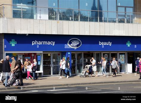 Shoppers outside Boots healthcare store on Princes Street Edinburgh Stock Photo - Alamy