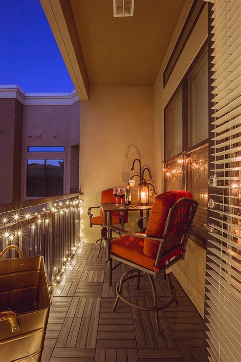 A small balcony light up at night by string lights and candles Condo ...