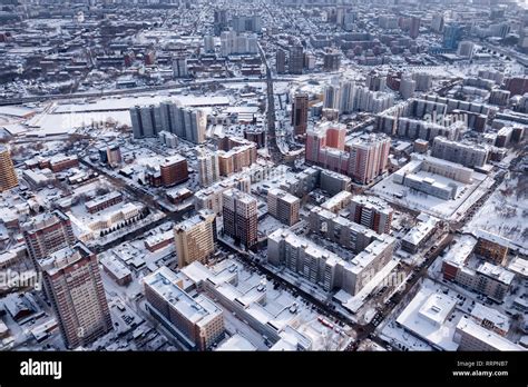 Winter landscape from a aerial view of the city of Novosibirsk, of the streets with a road, tall ...