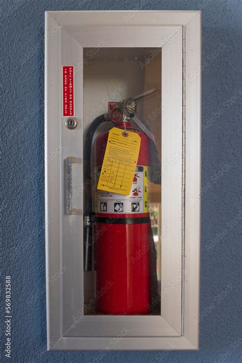 Fire extinguisher inside a cabinet with glass and aluminum frame on a ...