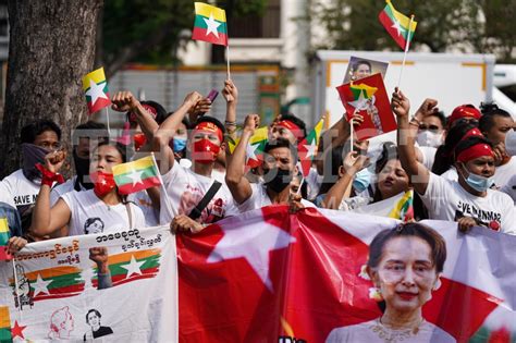 Protesters hold picture and waving the Myanmar flags - The Shot