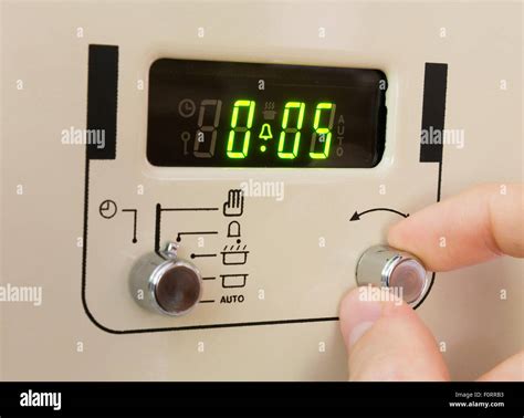 Setting a cooker timer to 5 minutes Stock Photo - Alamy