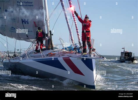 Pip Hare sets off a flare as she sails her boat Medallia into Poole, Dorset, after completing ...