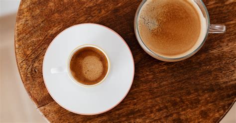 Coffee in small and big cups on round table · Free Stock Photo
