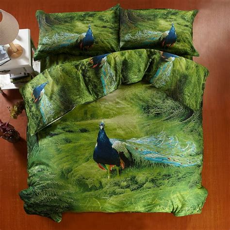 peacocks are walking in the green grass on this bedding set with ...