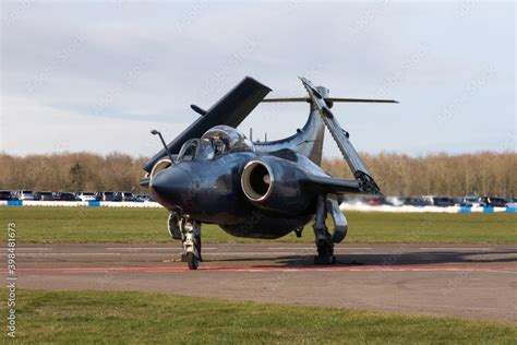 Cold War military jet bomber taxying in with wings folded. Stock Photo ...