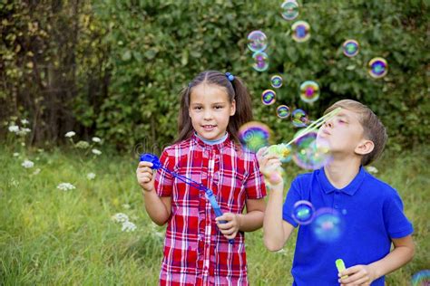 Kids playing with bubbles stock photo. Image of little - 105187378