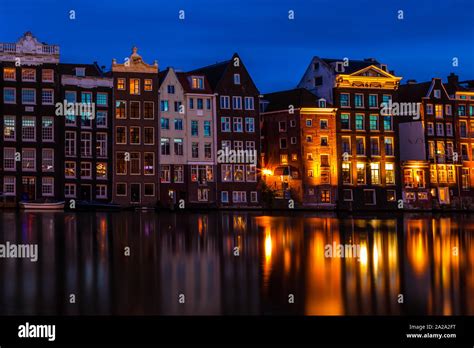 Amsterdam's Damrak at twilight Stock Photo - Alamy