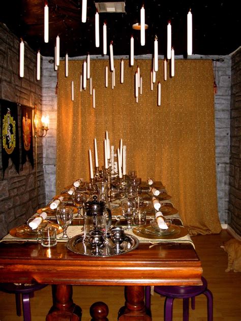 a long table with candles hanging from the ceiling