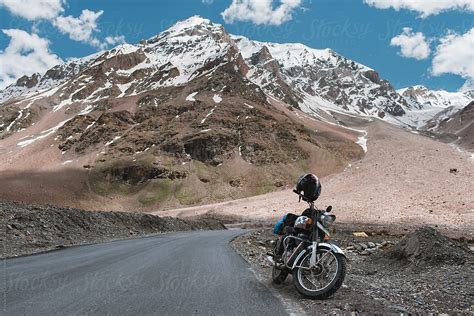 "Motorbike Parked On A Mountain Road" by Stocksy Contributor "Alexander Grabchilev" - Stocksy