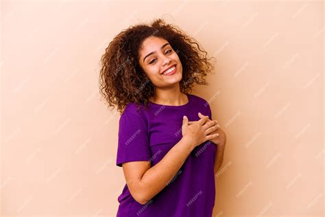 Premium Photo | Young african american woman isolated on beige wall has friendly expression ...