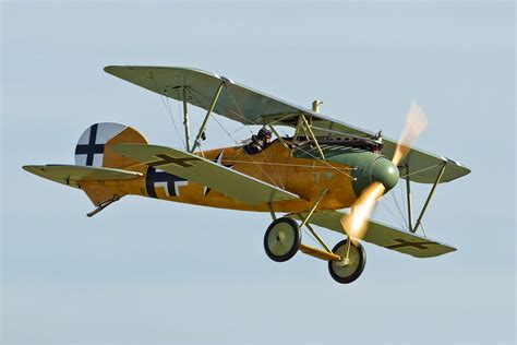 an old fashioned airplane flying in the sky