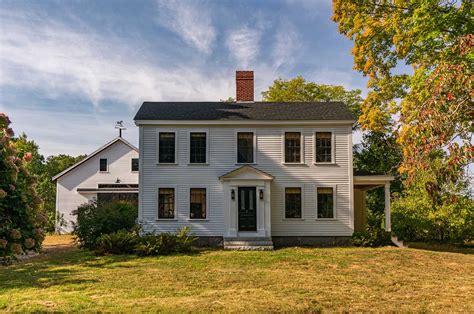 A historical New England farmhouse is restored to its former glory