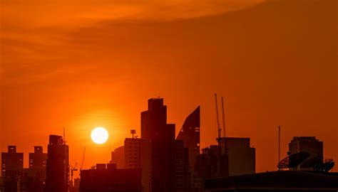 Premium Photo | Building in downtown at dusk with beautiful sunset sky. silhouette of condo and ...