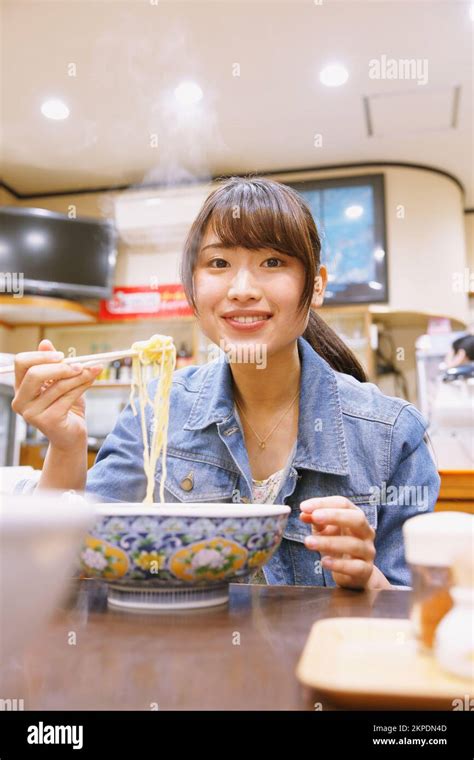 Japanese woman eating tantan noodles Stock Photo - Alamy