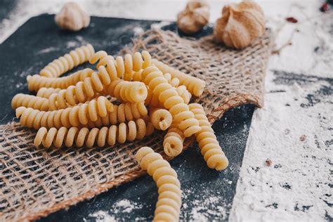 Raw italian pasta in a cooking background on black table - Creative Commons Bilder