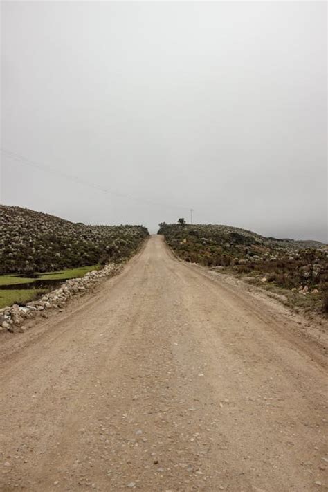 Brown Dirt Road Under White Sky · Free Stock Photo