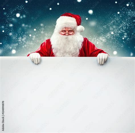 Santa Claus holding blank advertisement banner background with copy ...