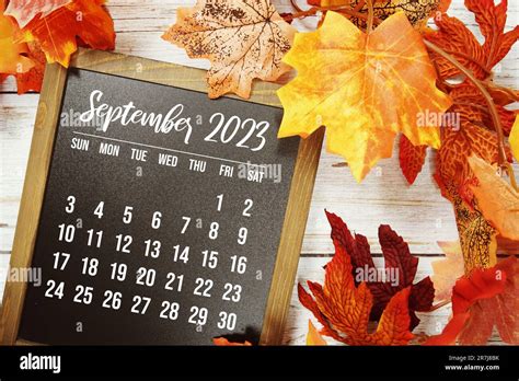 September 2023 monthly calendar with maple leaf on wooden background Stock Photo - Alamy