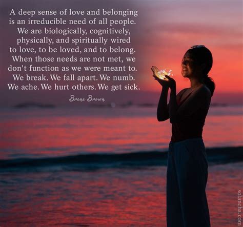 a woman standing on the beach holding a lit candle in her hand with a ...