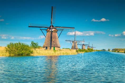 Wooden Windmills on the Lake Shore in Kinderdijk Museum, Netherlands Stock Photo - Image of ...