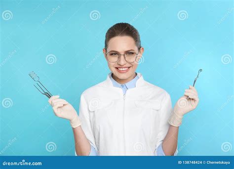 Female Dentist Holding Professional Tools Stock Photo - Image of female ...