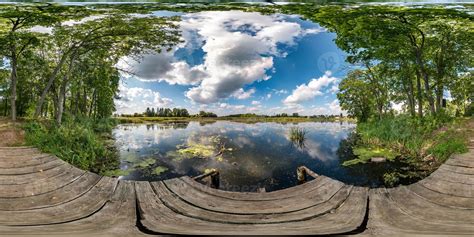 full seamless spherical hdri panorama 360 degrees angle view on wooden pier among the bushes of ...