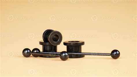 metal black tunnels , ear and tongue piercing accessories 16242935 Stock Photo at Vecteezy