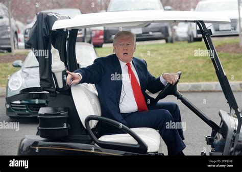 Donald Trump, chairman of The Trump Organization arrives in a golf cart ...