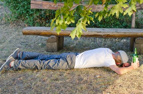 Drunk man sleeping it off in a park — Stock Photo © ampack #30990273