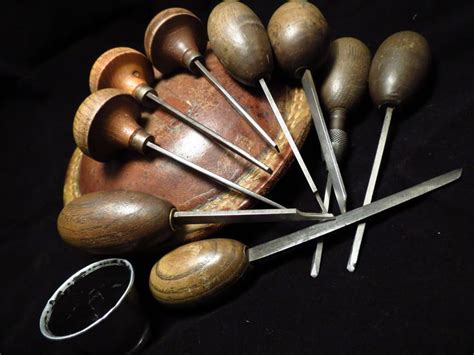 Traditional hand engraving tools - a selection of gravers, sandbag and ...