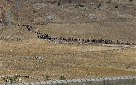 200 displaced Syrians gather at Israeli border fence as Russia bombs ...