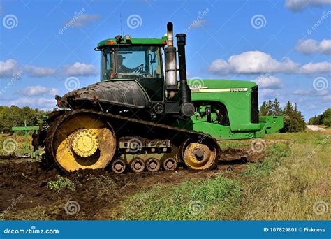 John Deere Tractor Pulling Machinery in the Mud Editorial Photo - Image of muddy, towing: 107829801