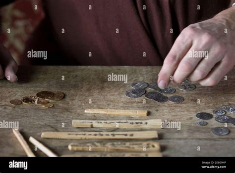 Medieval merchant counting money using tally sticks Stock Photo - Alamy