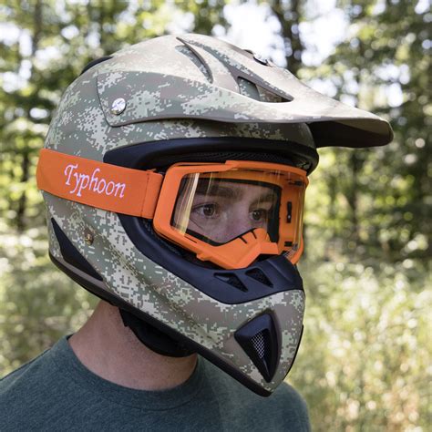 a man wearing a helmet with an orange visor and goggles on his face