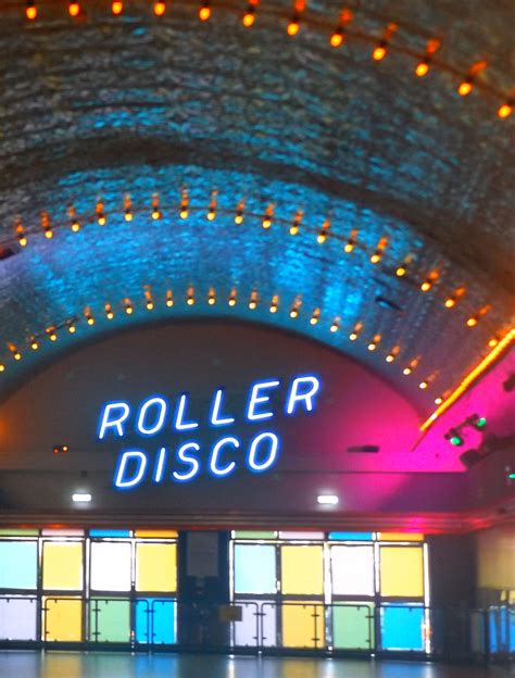 the entrance to roller disco at night with neon lights in the ceiling ...